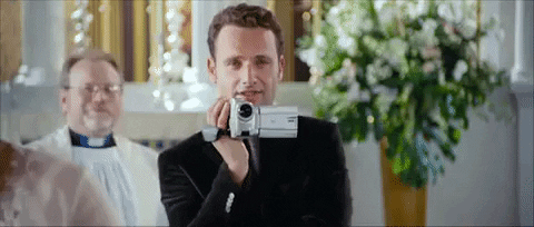 Andrew Lincoln holding a video camera.