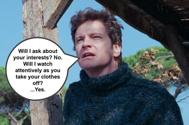 Colin Firth looking confused in a jumper in a scene from Love Actually.