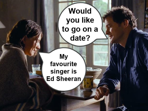 Lúcia Moniz and Colin Firth talking in a scene from Love Actually.