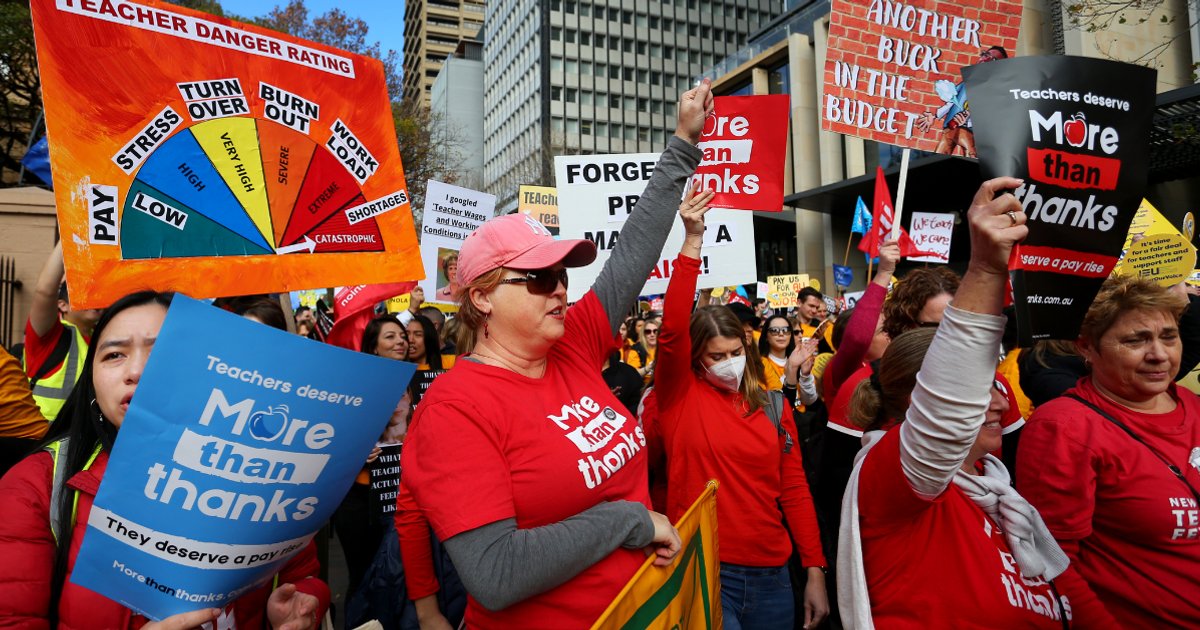 Striking teachers march to NSW parliament.