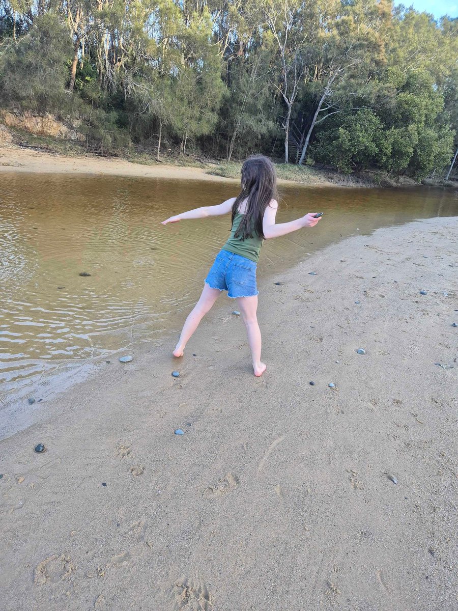 Child exploring creekside nature trail near Coffs Harbour.