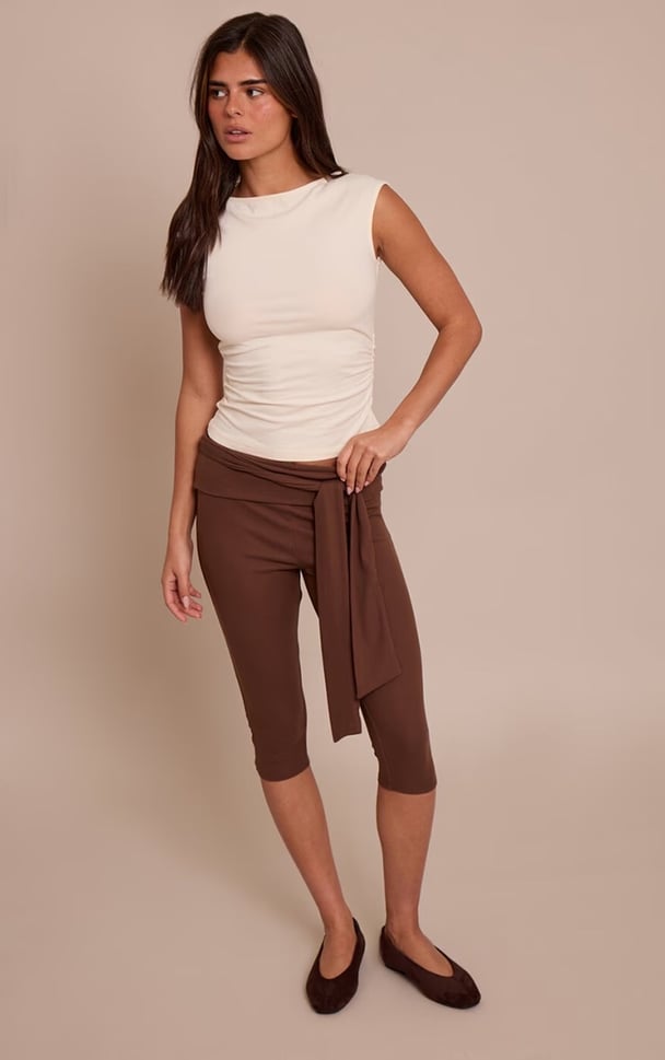 woman wearing soft stretch fabric capri in a neutral brown tone
