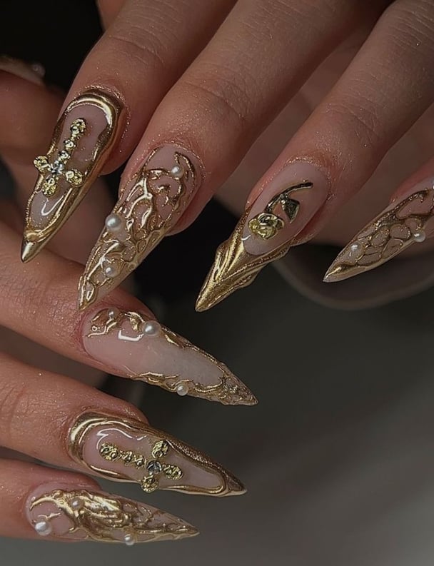 Gold jewel-toned nail design.