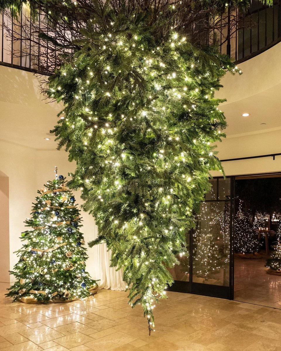 Two Christmas trees in Kourtney Kardashian's home, one of them hanging upside down.