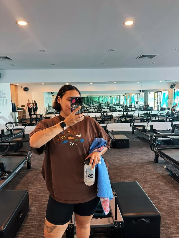 Influencer Allira Potter takes a mirror selfie after a Pilates class.