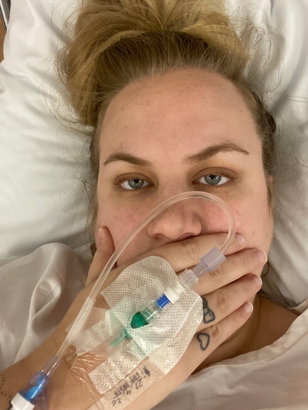 caitlin-in-hospital-bed-with-white-fown-and-drip