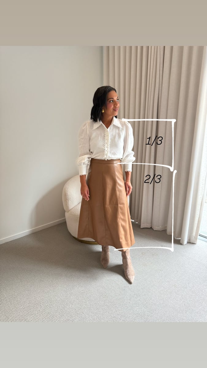 Emelia Morris demonstrates the rule of thirds in fashion with a white blouse, brown maxi skirt, and suede boots alongside a proportion sketch.