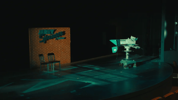 A camera and Jerry Springer Show sign on a stage.