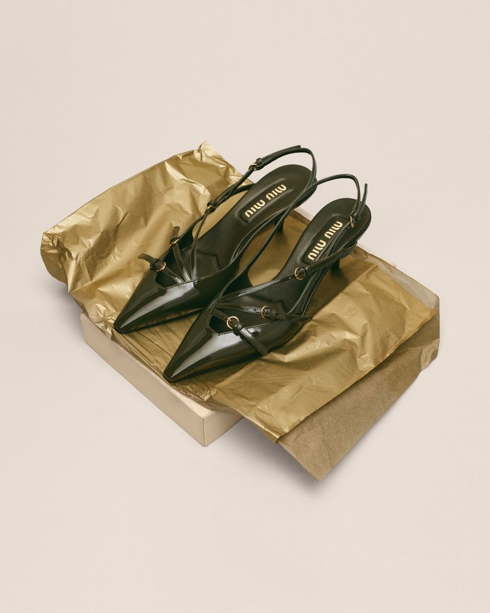 A pair of Miu Miu patent leather slingback heels in black.