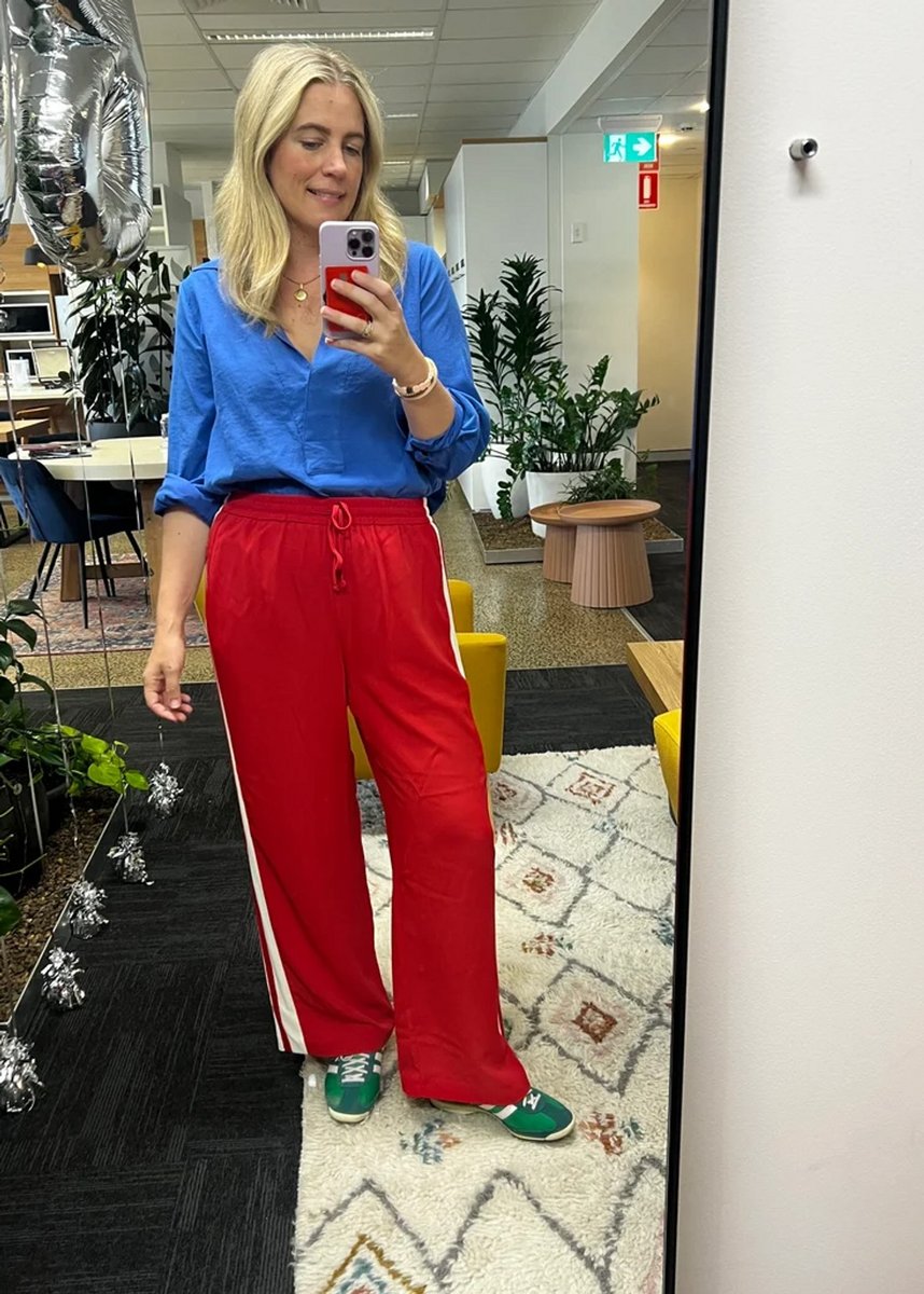 woman wearing red pants and blue top 