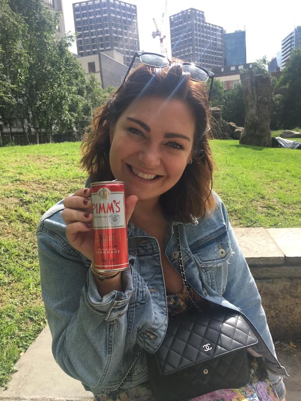 Woman drinking Pimm's in Londaon park.