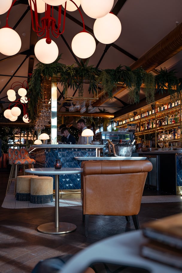 A bar at The Montenotte in Cork, showing a leather chair and table setting.