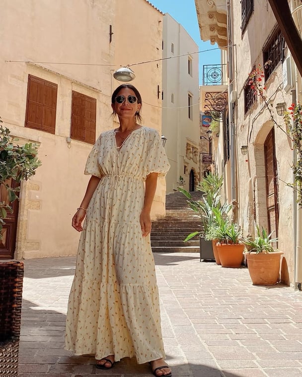 Author wears a maxi-dress and leather sandals.