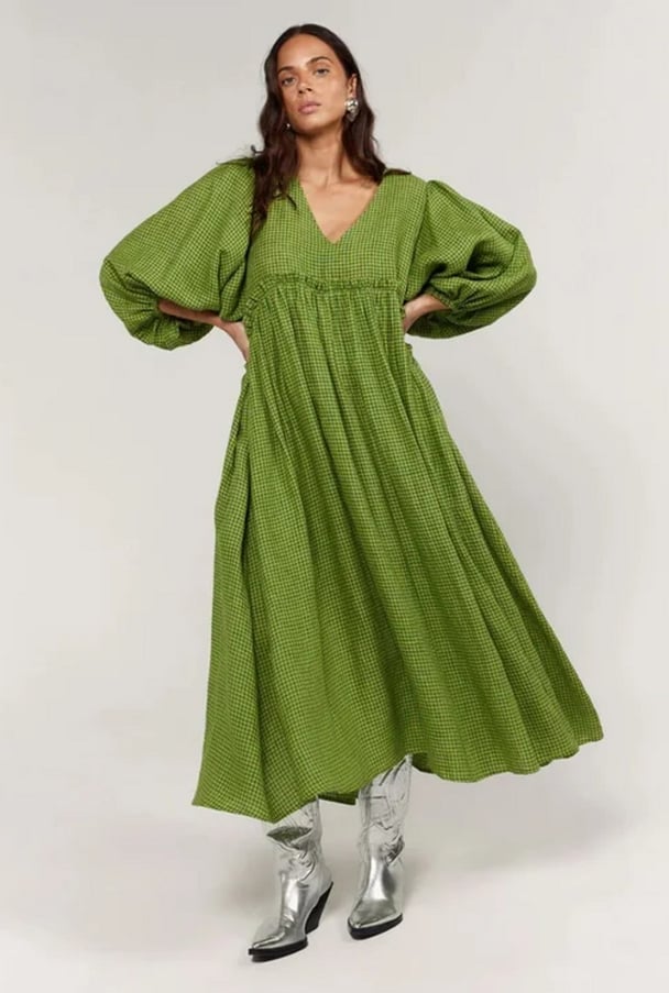 woman wearing a flowy green dress with metallic silver boots La Bohème Girls Marlowe Midi Dress