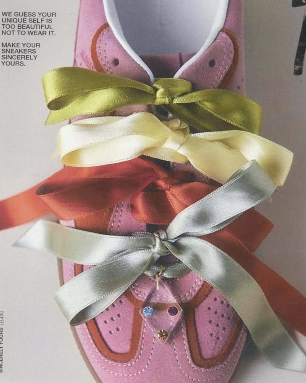 Pink sneakers customised with satin laces.