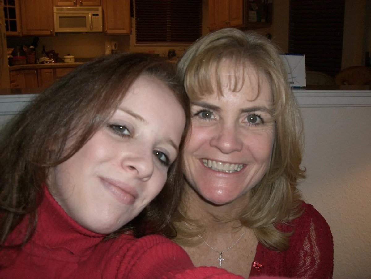 Brand Malonson with her mother. They are both wearing red. 