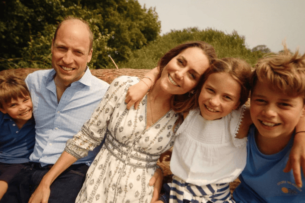 William and Kate smiling with their children, Louis, Charlotte and George.