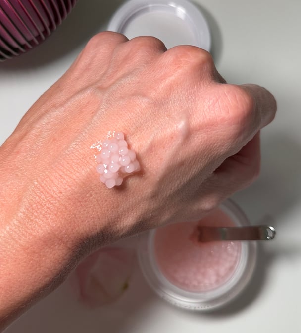 The plumping pearls are placed on the back of the writer's hand to see, up close, the soft gel-like pearl texture.