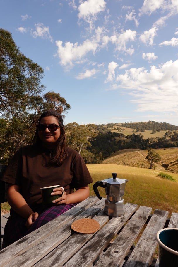 Sipping coffee outside the cabin.