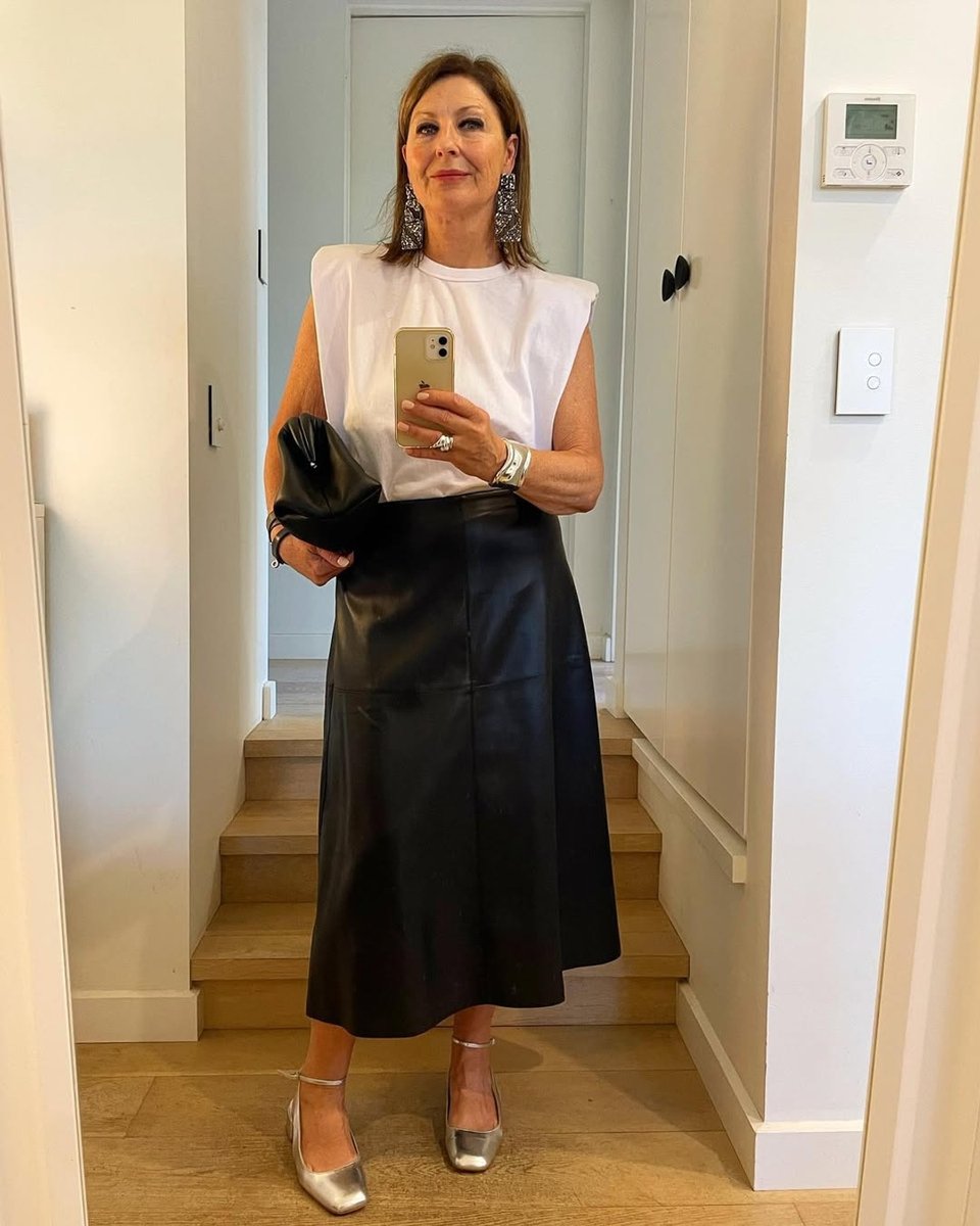 Personal stylist Fifi Milne contrasts her edgy white tank with a leather skirt.