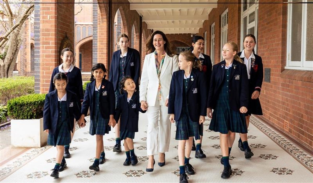 Pymble Ladies College principal Dr Kate Hawden with nine students of varying ages.