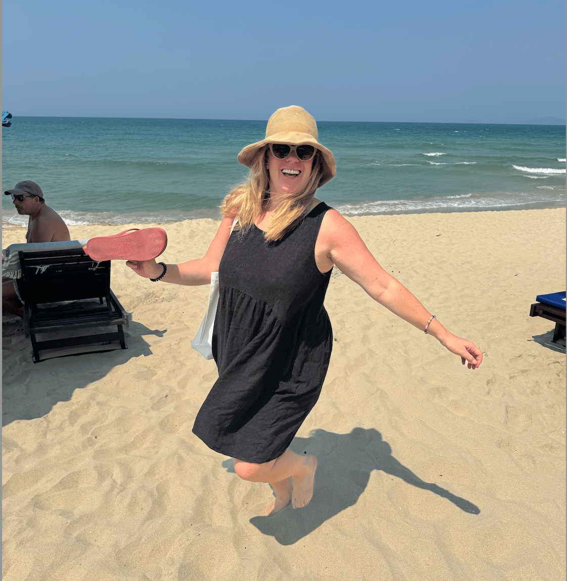 A woman enjoys herself bare-foot on An Bang Beach.