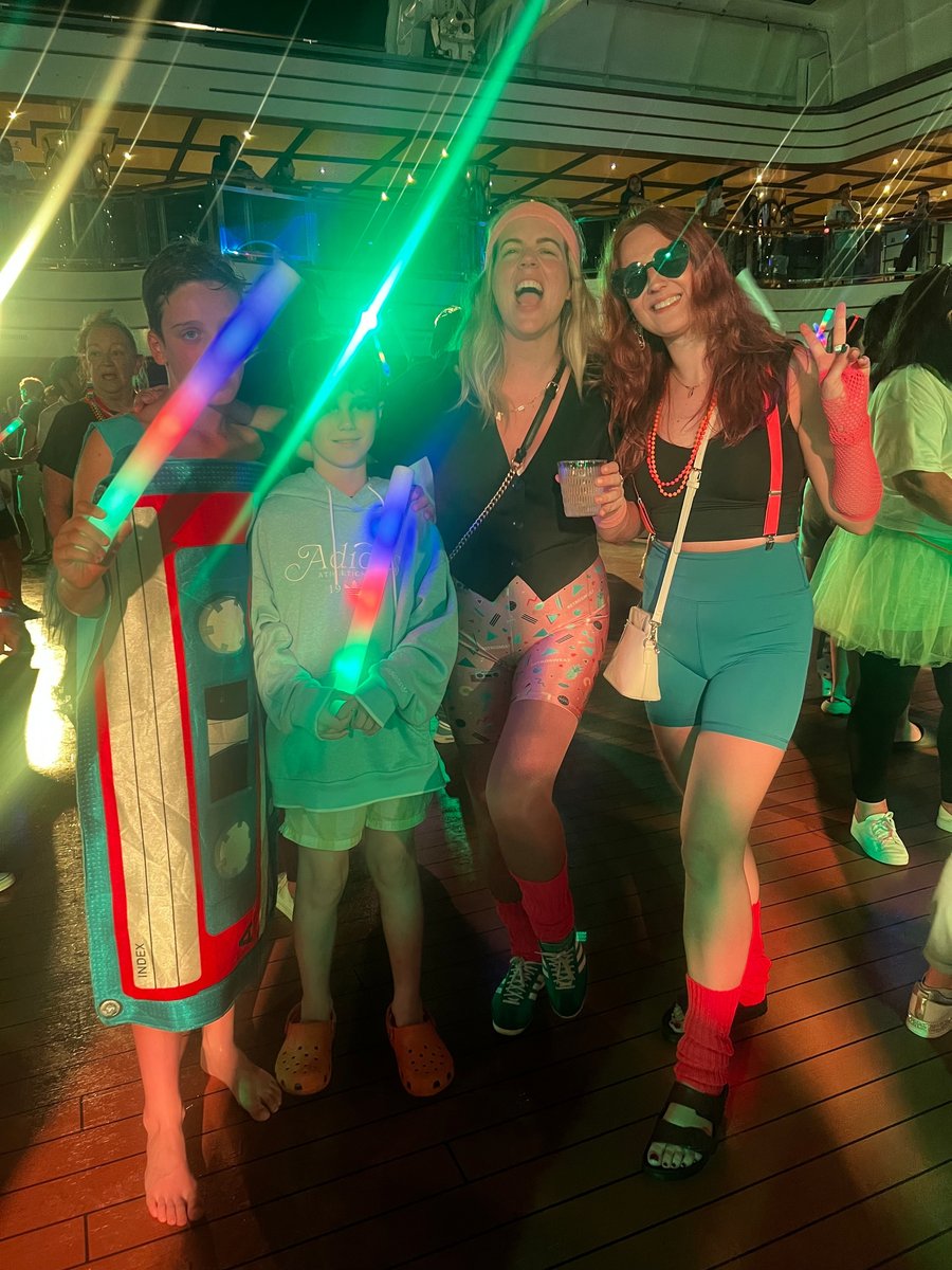 Two women and two women dressed in '80s-themed costumes during a disco night. 