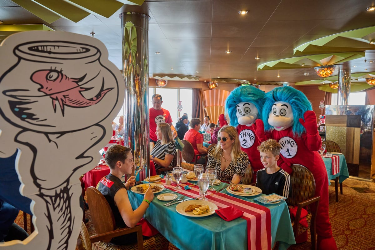 A family having a Dr. Seuss themed breakfast on a cruise ship with Thing 1 and Thing 2.