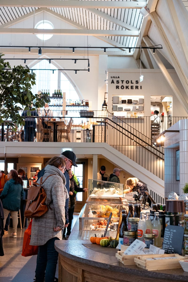 Inside Feskorka in Gothenburg, showing a cafe with an elderly couple looking in the food display.