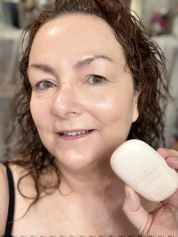 Beauty writer Teresa McNamara holding Kylie Cosmetics Skin Tint, a hydrating base for mature skin.