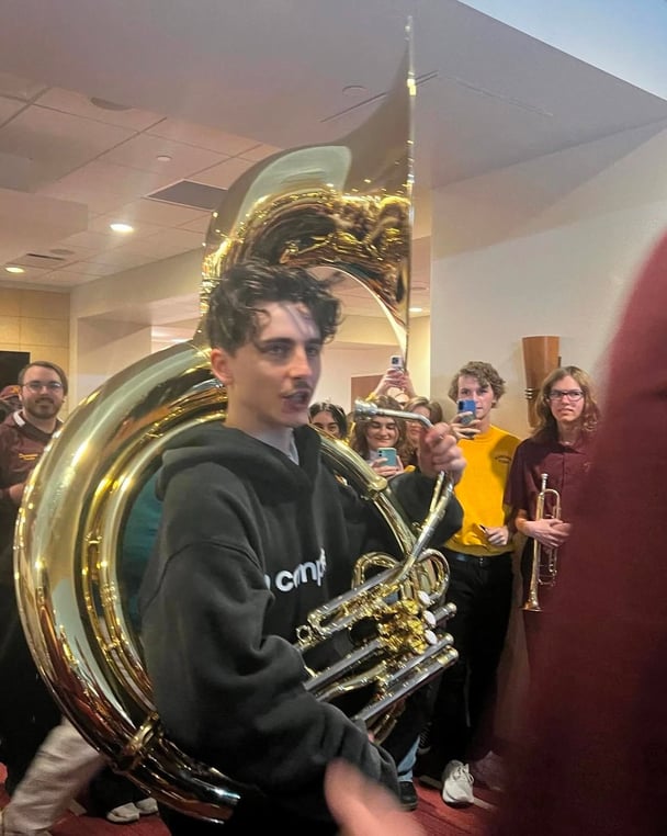 Timothee Chalamet plays the tuba while visiting the University of Minnesota marching band.