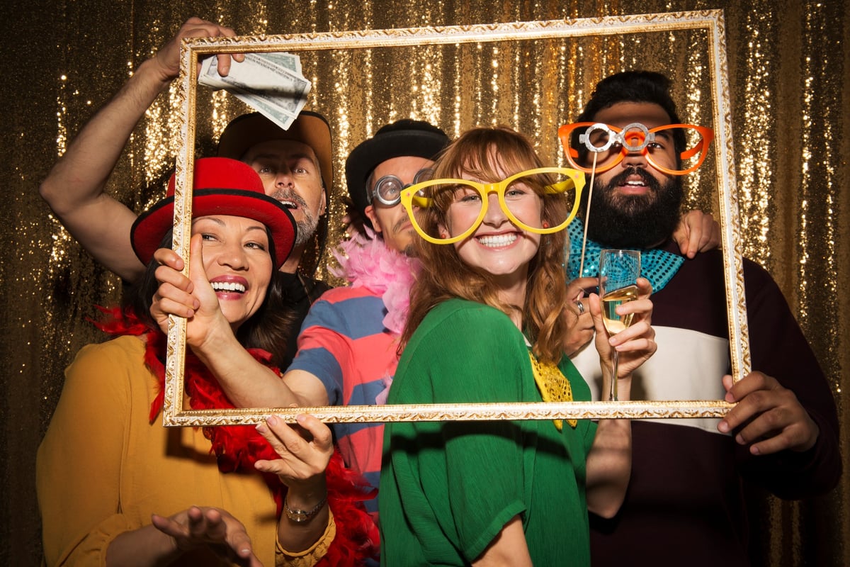 People in a photobooth at a wedding.