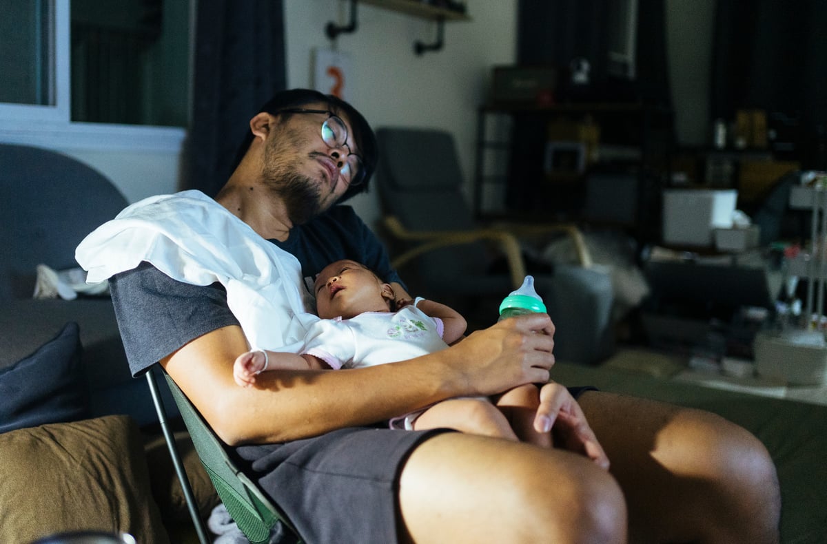 Man sleeping with baby on chest