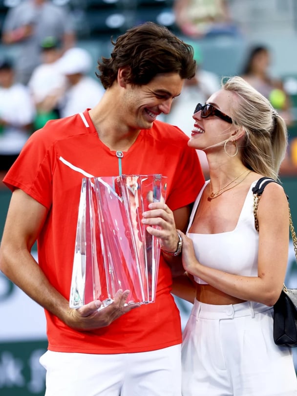 Taylor Fritz of the United States holds his winners trophy with his girlfriend Morgan Riddle after his straight sets victory against Rafael Nadal of Spain in the men's Final on Day 14 of the BNP Paribas Open