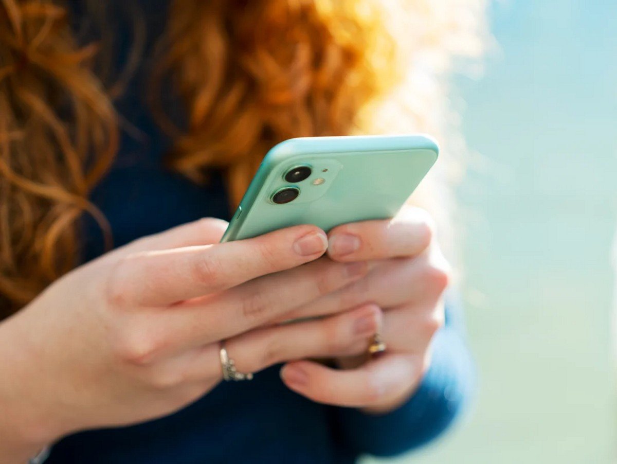 Close up or woman using smart phone.