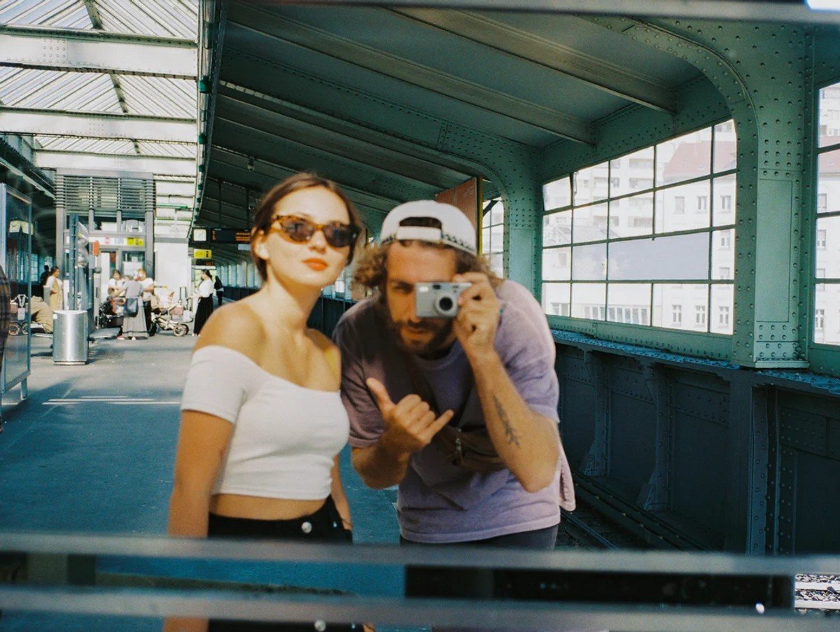 Man and woman taking a selfie in a mirror