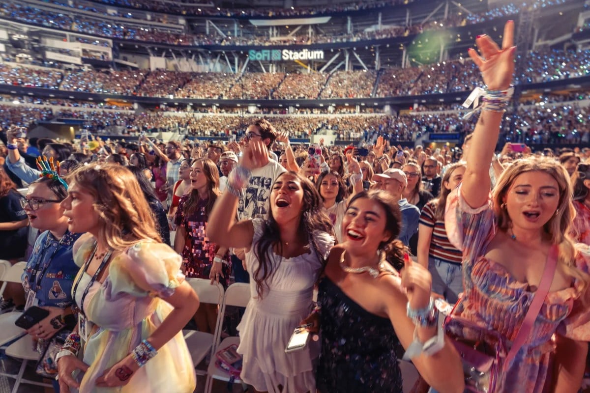 Fans singing and dancing at The Eras Tour at SoFi Stadium.