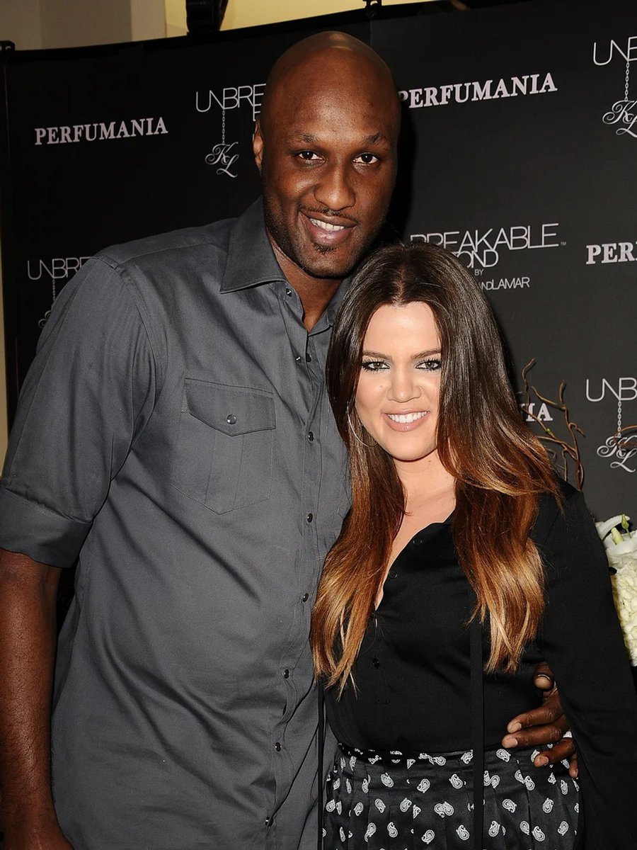 Lamar Odom and Khloe Kardashian pose together during an appearance for 