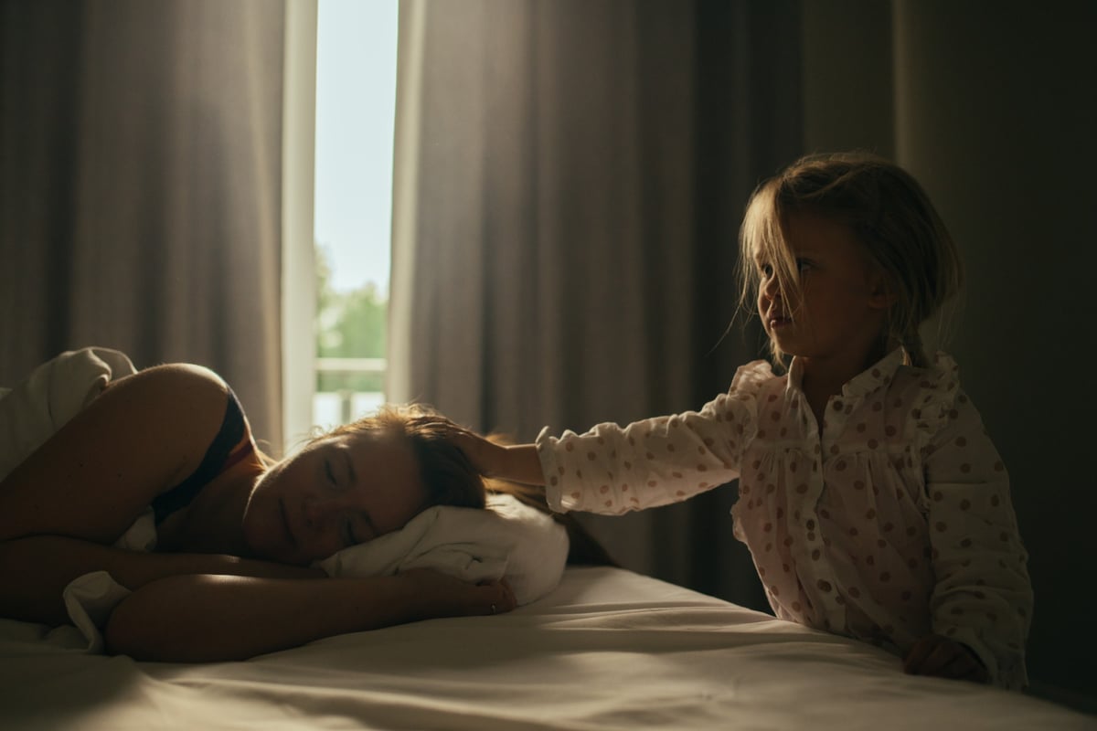 little girl wakes mum in morning