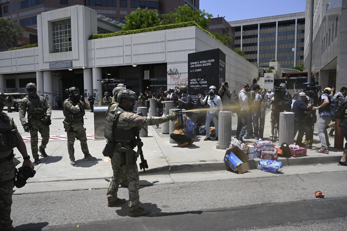 ICE officers and national guards confront with protesters outside of the Metropolitan Detention Center in Los Angeles.