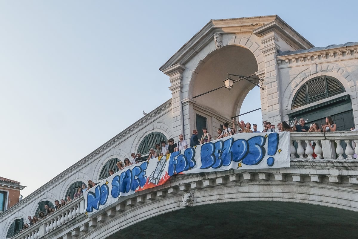 Protesters in Venice hang a sign ahead of Jeff Bezos' wedding
