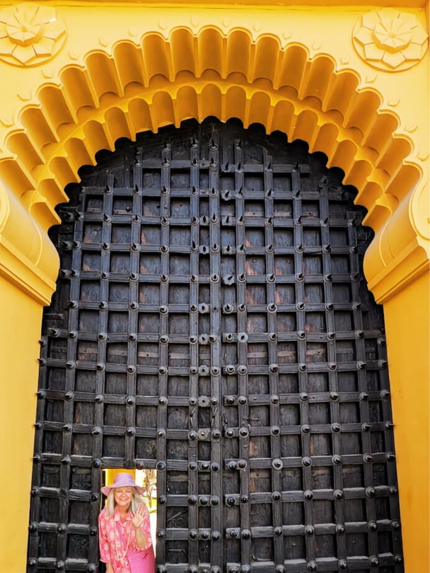 Jo looking out from a small door in the massive entrance of the Gogunda Palace.