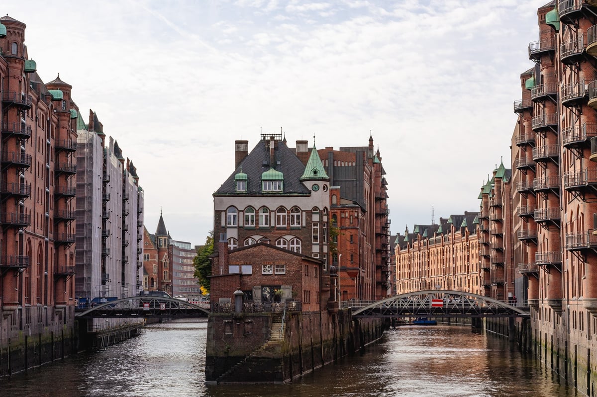 The Hamburg canals, with old buildings on either side, and protruding out in the middle. 