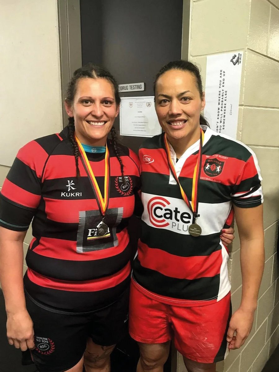 Author posing in footy league uniform, with her wife.