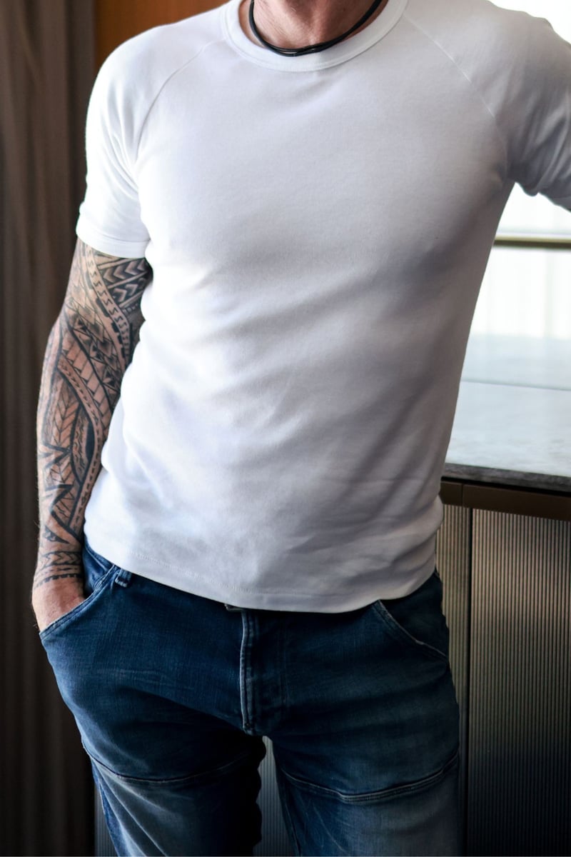 Hudson* pictured in a white t-shirt and jeans.