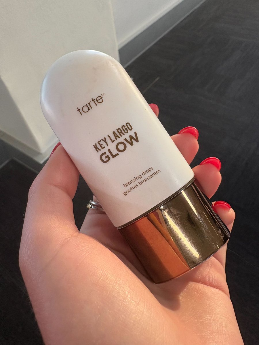 Tarte Cosmetics Key Largo Glow Bronzing Drops pictured in a hand.