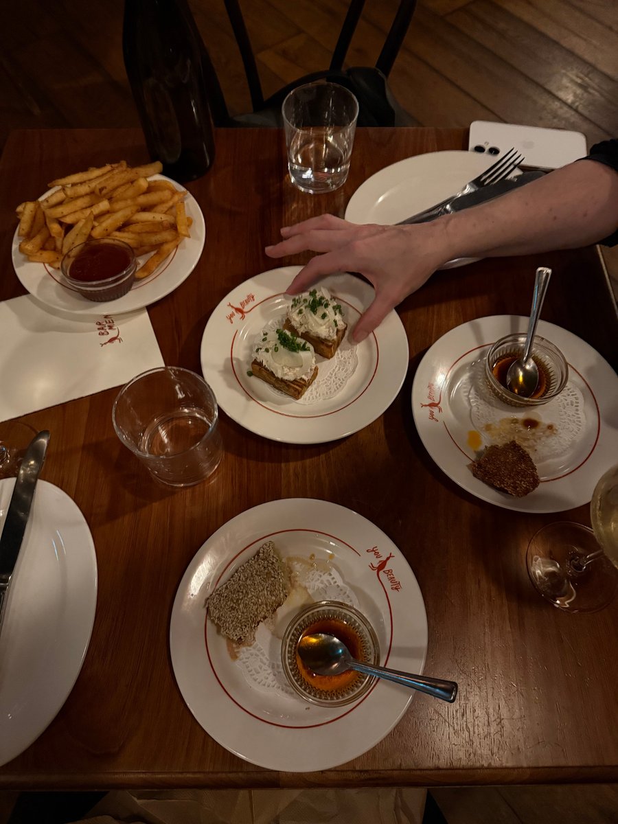 Half-eaten plates full of food at a restaraunt.