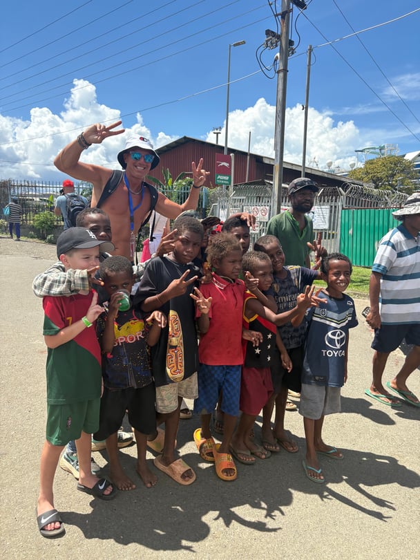 Nicole's family members pose for pictures with village children.