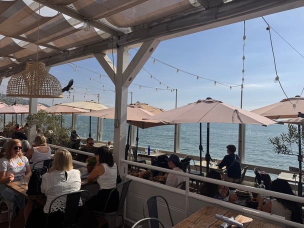 An outdoor restaurant overlooking the ocean.