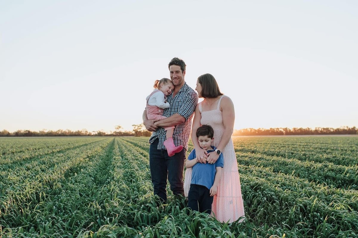 Hamey Hayllor posing in a farm with her two kids and Farmer husband.